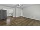 Hardwood floors leading to an open view of the kitchen with stainless steel refrigerator at 874 Colony Drive # B19, Charleston, SC 29407