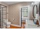 Elegant bathroom with patterned wallpaper, a glass shower, and a modern vanity at 90 Spring St # Ab, Charleston, SC 29403