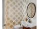 Stylish powder room with a unique sink and commode, and an eye-catching starburst patterned wall at 90 Spring St # Ab, Charleston, SC 29403