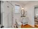 Stylish bathroom with glass shower, white vanity, and window letting in natural light at 90 Spring St # Ab, Charleston, SC 29403