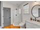 Stylish bathroom featuring glass-enclosed shower, white vanity, and elegant fixtures at 90 Spring St # Ab, Charleston, SC 29403