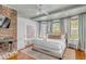 Inviting bedroom featuring a brick fireplace, soft lighting, and neutral tones at 90 Spring St # Ab, Charleston, SC 29403
