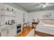 Bedroom features hardwood floors, ceiling fan, wet bar, and a view of the bedroom and bathroom at 90 Spring St # Ab, Charleston, SC 29403