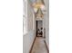 A hallway shows decorative wallpaper, pendant lighting and hardwood floors leading to the bedroom at 90 Spring St # Ab, Charleston, SC 29403