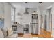 A well-appointed kitchen features stainless steel appliances, white cabinetry, and open shelving at 90 Spring St # Ab, Charleston, SC 29403