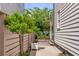 This charming side yard features a small tree and brick lined garden along a white wooden fence at 90 Spring St # Ab, Charleston, SC 29403