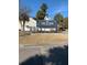 Welcoming sign for The Orchards community entrance with lush landscaping and palm trees under a clear blue sky at 9028 Maple Grove Dr, Summerville, SC 29485
