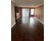 An open-concept living room with hardwood floors, bright natural light, and neutral paint tones at 9028 Maple Grove Dr, Summerville, SC 29485