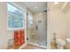 Bright bathroom with glass shower, stylish fixtures, and warm tile flooring at 928 Ashley Ave, Charleston, SC 29403