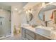 Elegant bathroom showcasing double vanities, decorative tile accents, and glass shower at 928 Ashley Ave, Charleston, SC 29403