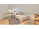 Attic bedroom featuring a cozy bed, area rug, and stylish decor at 928 Ashley Ave, Charleston, SC 29403