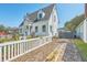 Charming home with a white picket fence, lush landscaping, and a brick driveway leading to the house at 928 Ashley Ave, Charleston, SC 29403