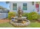 Close-up of a birdbath in a well-maintained front yard, surrounded by lush greenery at 928 Ashley Ave, Charleston, SC 29403