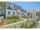 Charming home featuring a manicured lawn, colorful flowerbeds, a fountain, and a classic white picket fence at 928 Ashley Ave, Charleston, SC 29403