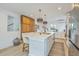 Stylish white kitchen featuring a center island, stainless steel appliances, and light hardwood flooring at 928 Ashley Ave, Charleston, SC 29403