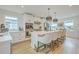Bright and airy kitchen with an island, bar seating, and updated stainless steel appliances at 928 Ashley Ave, Charleston, SC 29403