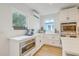 Well-lit kitchen showcasing stainless steel appliances, custom cabinetry, and sleek countertops at 928 Ashley Ave, Charleston, SC 29403