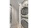 Bright laundry room with modern stacked washer/dryer and stylish herringbone tile flooring at 928 Ashley Ave, Charleston, SC 29403