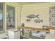 Covered patio with unique fish art on the wall and mini fridge at 928 Ashley Ave, Charleston, SC 29403