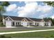 Charming row of single-Gathering homes each with an attached one-car garage and manicured lawns against a bright blue sky at 943 Dusk Dr, Summerville, SC 29486