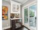 Stylish bar area with wine cooler, custom cabinets, and access to outdoor patio at 10 Logan St # 6, Charleston, SC 29401