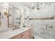 Elegant bathroom featuring double vanity, marble countertop, and glass-enclosed shower at 10 Logan St # 6, Charleston, SC 29401