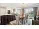Well-lit dining area with a modern chandelier, adjacent to a stylish kitchen, perfect for Gathering gatherings at 10 Logan St # 6, Charleston, SC 29401