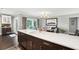 Spacious kitchen island with bar seating, leading to an open dining area with modern lighting and decor at 10 Logan St # 6, Charleston, SC 29401