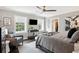 Spacious primary bedroom with a ceiling fan, large windows, and a walk-in closet at 10 Logan St # 6, Charleston, SC 29401