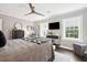 Comfortable primary bedroom featuring a ceiling fan, windows, and a dresser at 10 Logan St # 6, Charleston, SC 29401