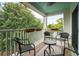 Relaxing covered patio with comfortable seating, ceiling fan and view of lush greenery at 10 Logan St # 6, Charleston, SC 29401