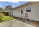 A backyard patio features a white door and window with a garden hose hanging on the exterior wall at 100 Bridgetown Rd # 10B, Goose Creek, SC 29445