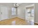 Well-lit dining area with hardwood floors, modern chandelier, and seamless access to kitchen at 100 Bridgetown Rd # 10B, Goose Creek, SC 29445