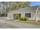 Exterior showcasing a one-car garage, neat landscaping, neutral siding, and an inviting entryway at 100 Bridgetown Rd # 10B, Goose Creek, SC 29445
