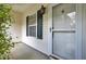 Inviting covered front porch showcasing white siding, and a classic entry door with black shutters at 100 Bridgetown Rd # 10B, Goose Creek, SC 29445
