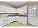 Functional kitchen has white cabinetry and essential appliances at 100 Bridgetown Rd # 10B, Goose Creek, SC 29445