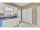 Well-lit kitchen with white cabinets, double sink, and storage at 100 Bridgetown Rd # 10B, Goose Creek, SC 29445