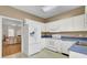 The kitchen opens to a living room, featuring white appliances at 100 Bridgetown Rd # 10B, Goose Creek, SC 29445