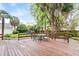 Large backyard features a wood deck, green lawn, garden, and a detached three car garage at 1034 Orangeburg Rd, Summerville, SC 29483