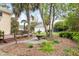 Landscaped backyard features a fountain, a three-car garage, and a trampoline at 1034 Orangeburg Rd, Summerville, SC 29483