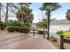 A wooden deck overlooks the spacious backyard and the detached three car garage at 1034 Orangeburg Rd, Summerville, SC 29483