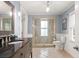 Bright bathroom featuring a wood vanity, frameless shower, and a toilet, exuding modern elegance at 1034 Orangeburg Rd, Summerville, SC 29483