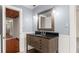 Bathroom vanity with black countertop and wood drawers, framed mirror, and light gray walls at 1034 Orangeburg Rd, Summerville, SC 29483