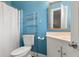 Full bathroom with toilet, vanity, tub with shower, and blue walls at 1034 Orangeburg Rd, Summerville, SC 29483