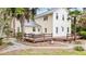Charming yellow two-story home featuring a metal roof and a spacious wooden deck for outdoor entertaining at 1034 Orangeburg Rd, Summerville, SC 29483