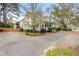 Well-maintained home featuring a charming porch, surrounded by vibrant greenery and a driveway at 1034 Orangeburg Rd, Summerville, SC 29483