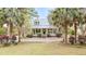 Charming two-story home with a welcoming front porch and well-manicured lawn, surrounded by lush trees at 1034 Orangeburg Rd, Summerville, SC 29483