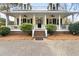 Inviting home with a welcoming porch, complete with manicured shrubs and a well-kept front yard at 1034 Orangeburg Rd, Summerville, SC 29483