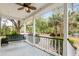Relaxing porch with a hanging swing, offering a serene view of the beautifully landscaped yard and mature trees at 1034 Orangeburg Rd, Summerville, SC 29483