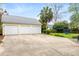Detached three car garage with a metal roof, surrounded by a lush green lawn at 1034 Orangeburg Rd, Summerville, SC 29483